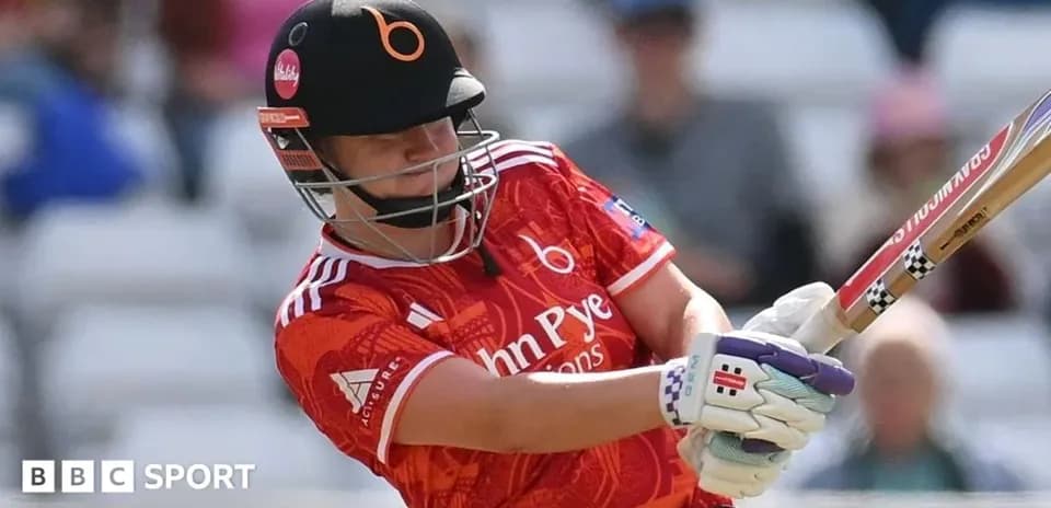 Batter striking the ball in a cricket match