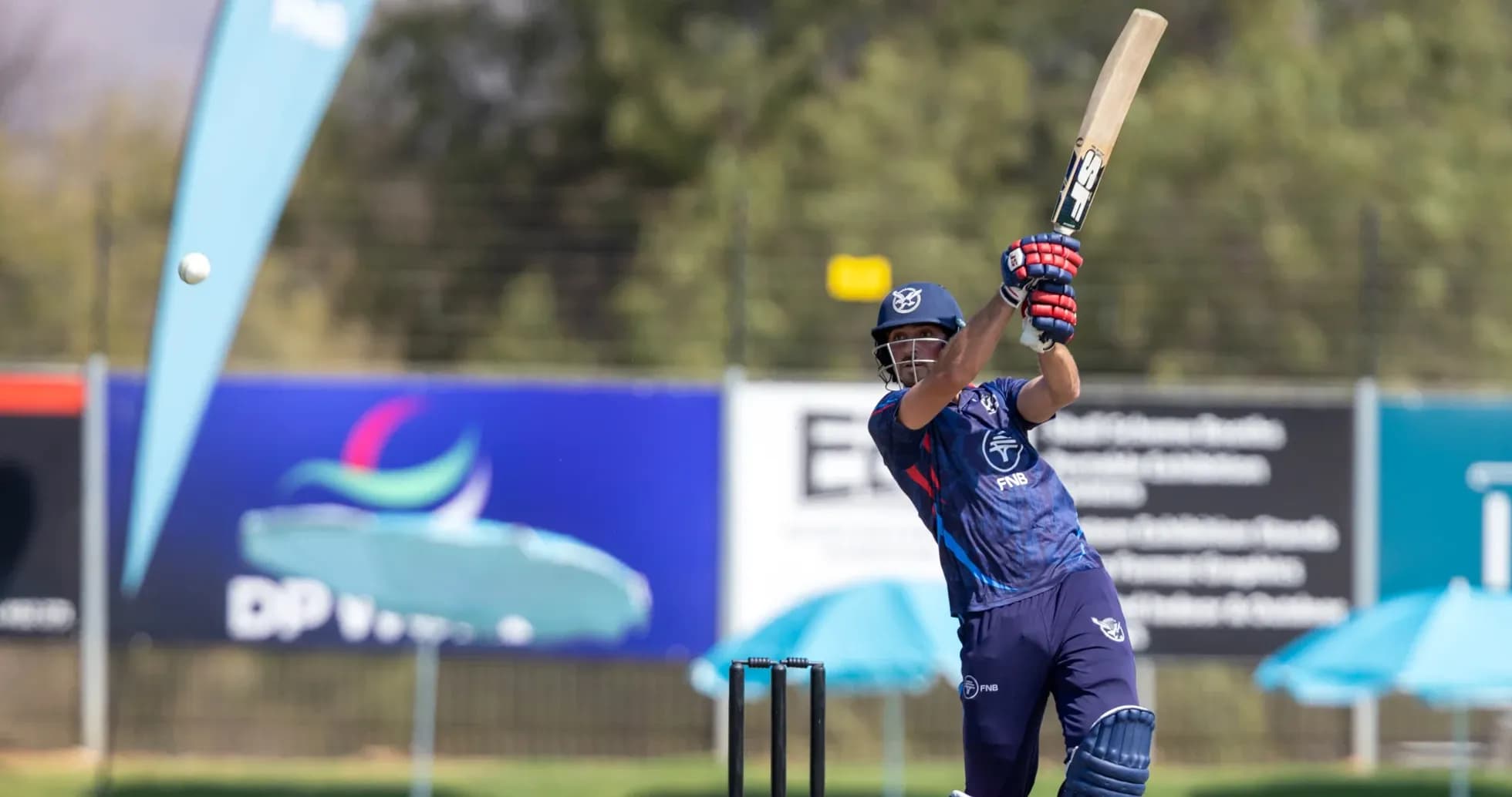 Batsman striking ball during cricket match