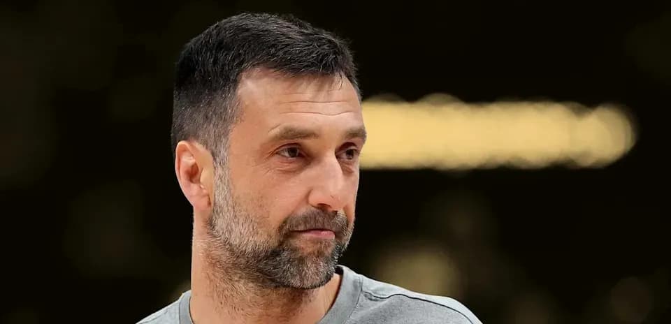 Man with short hair and beard, wearing a gray shirt