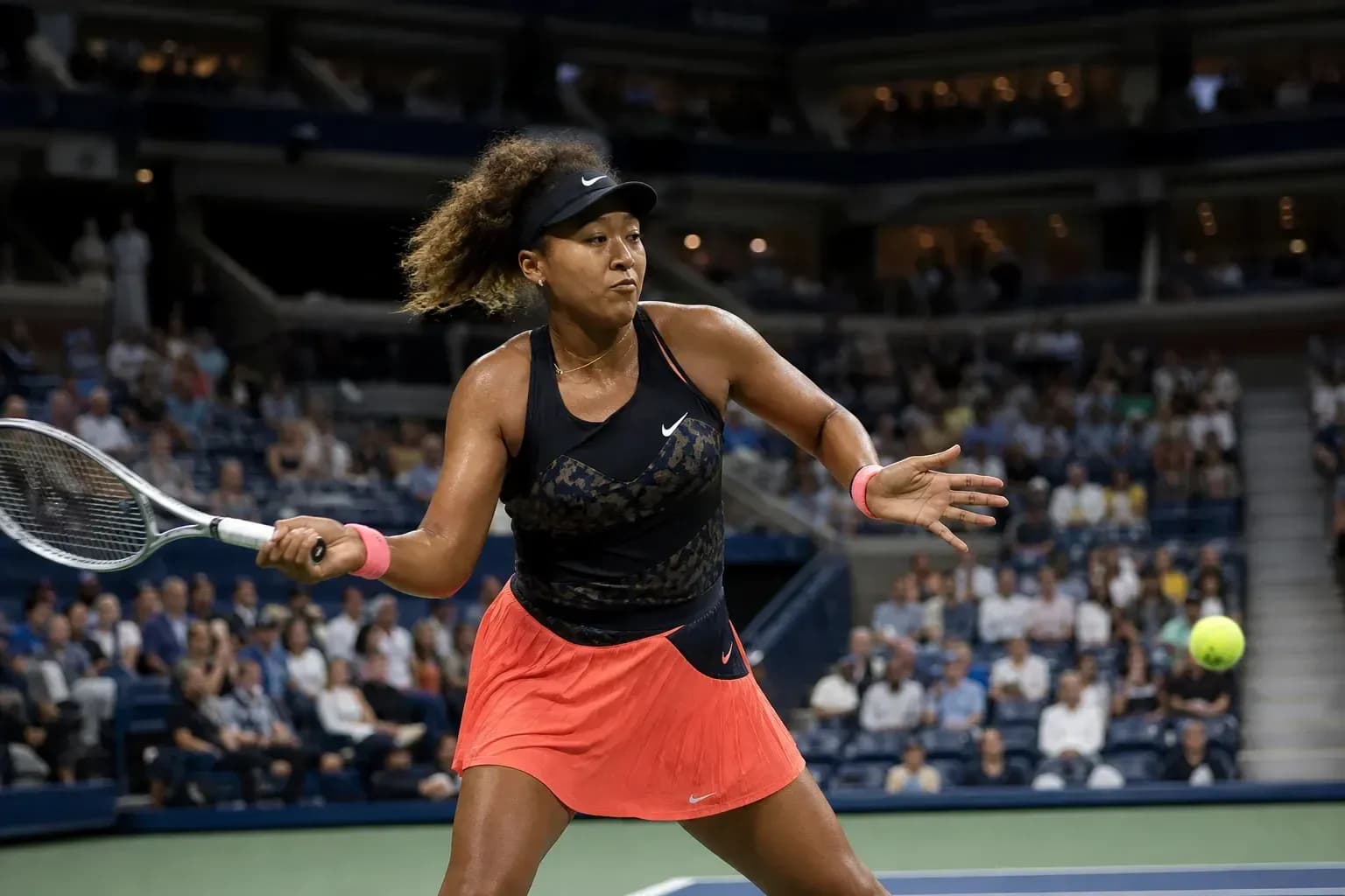 Naomi Osaka preparing to hit a tennis ball