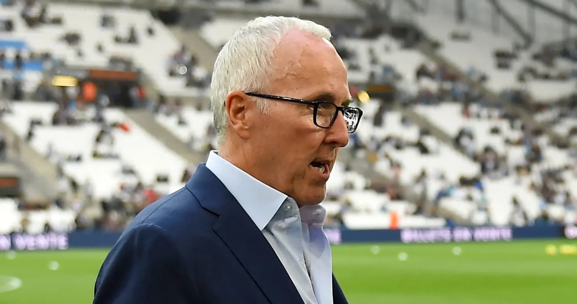Manager walking on the pitch before the match