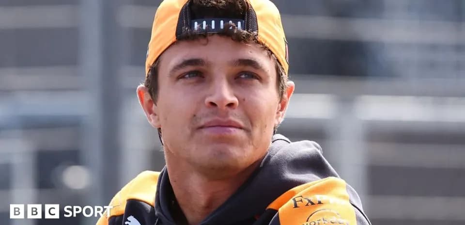 Driver wearing McLaren gear at racetrack