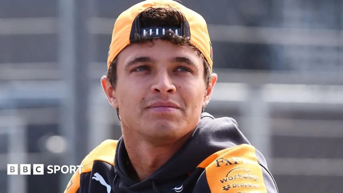 Driver wearing McLaren gear at racetrack