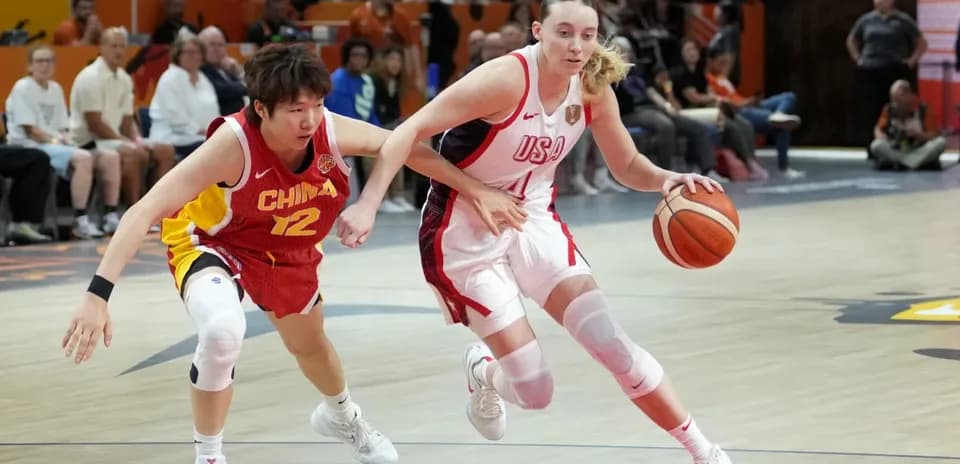 USA player dribbling while defended by China player