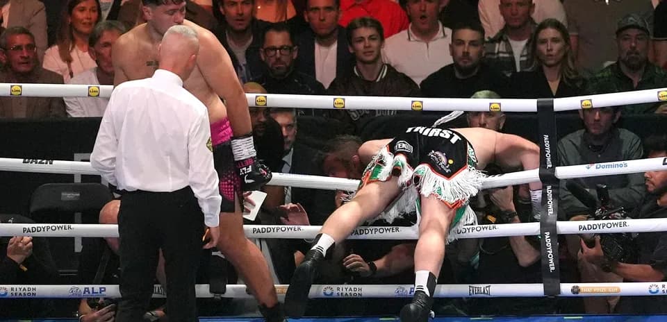 Boxer knocked down, referee checking on him