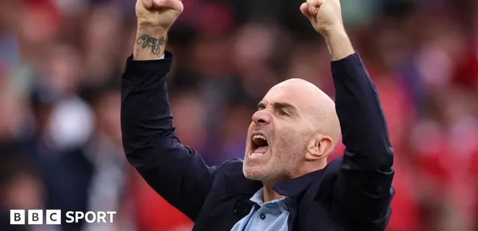 Coach celebrating with raised fists during match