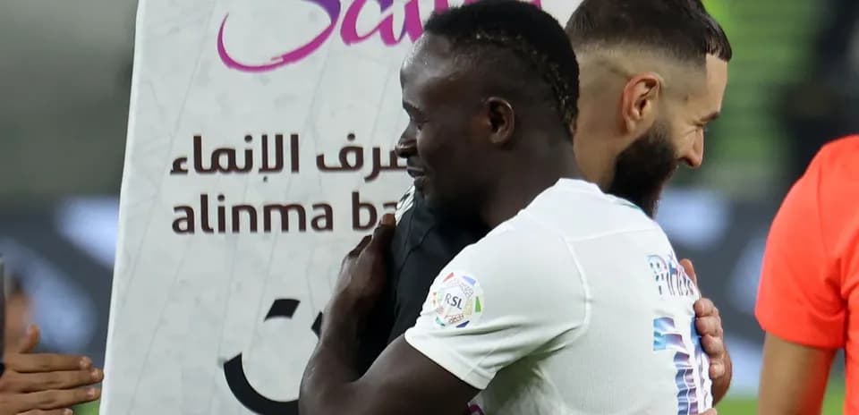 Players embracing after a match, team logos visible