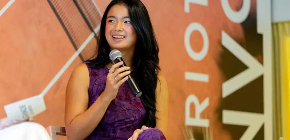 Speaker holding microphone during event presentation