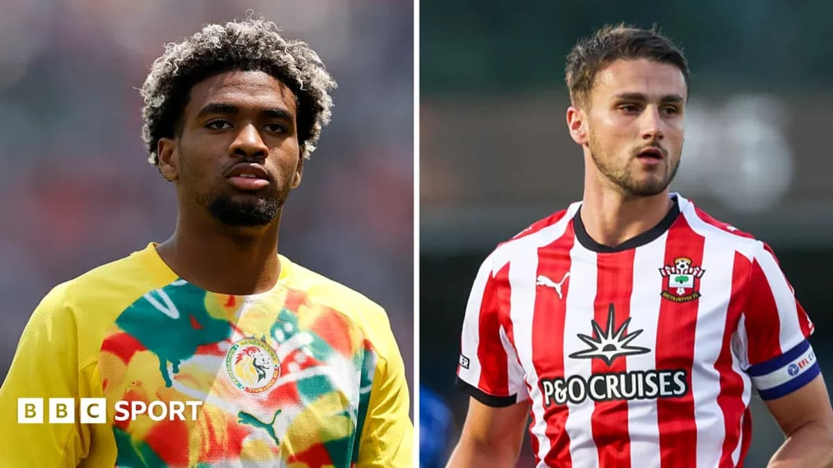 Two football players in team kits side by side