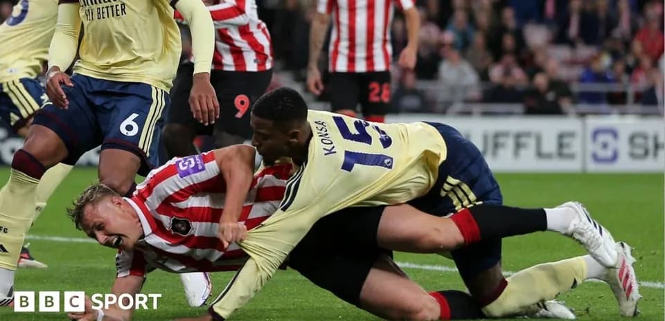 Players tangled during a competitive football match