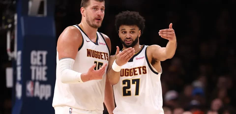 Nuggets players discussing strategy during a game