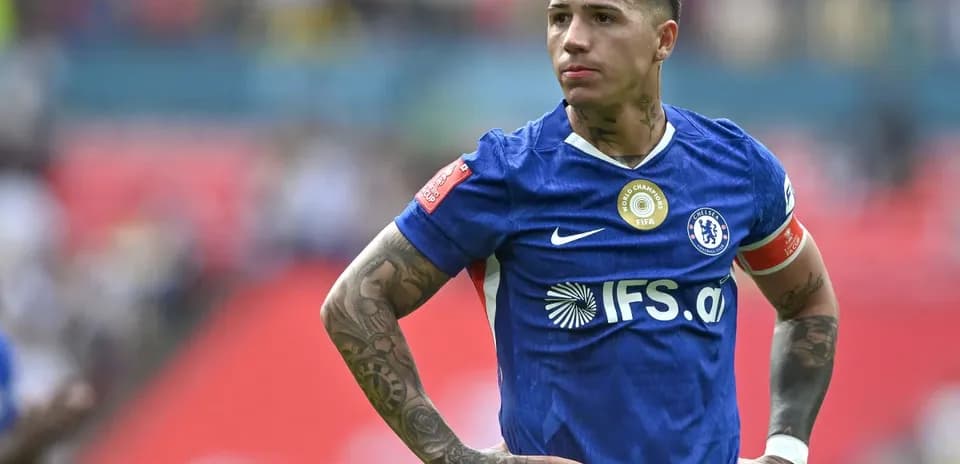 Player in blue jersey looking focused on field