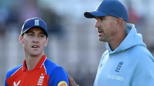 Two cricket players discussing strategy on field