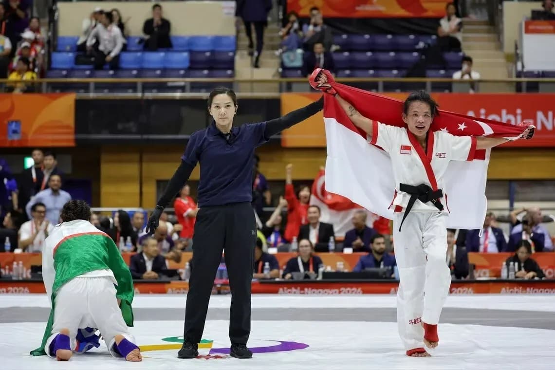Athlete celebrating victory with Singapore flag raised
