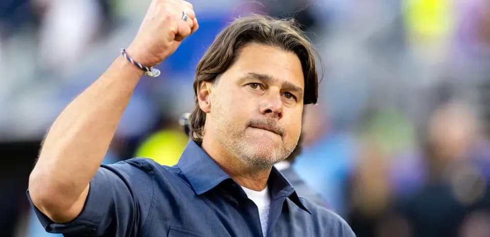 Coach celebrating with a raised fist during match