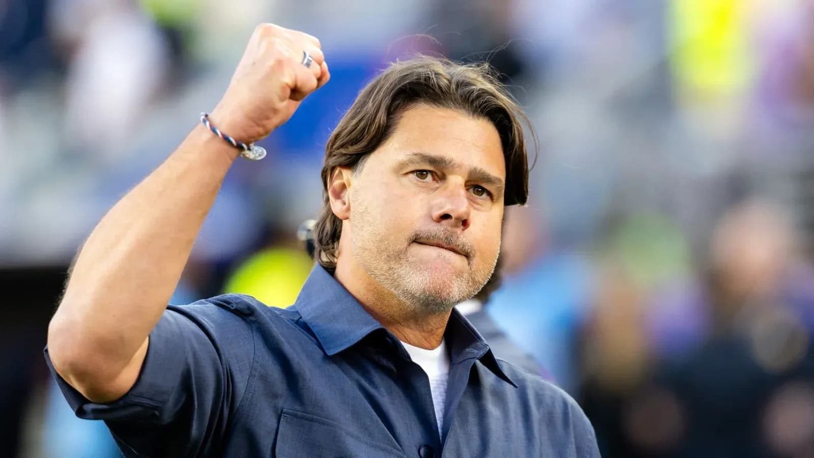 Coach celebrating with a raised fist during match