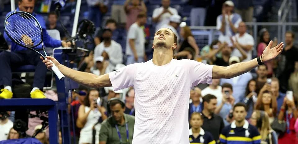Player celebrating with arms raised after match