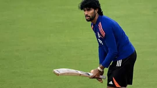 Cricketer practicing with bat on field