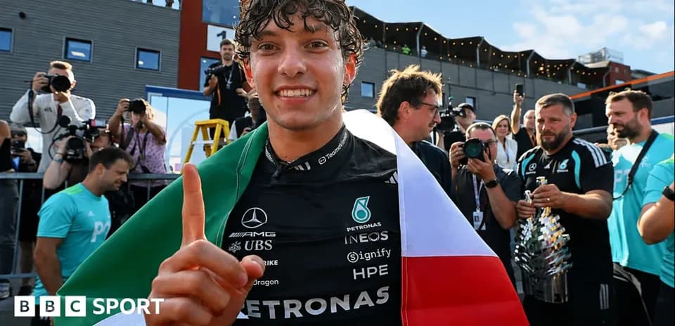 Driver celebrating with Italian flag after race victory