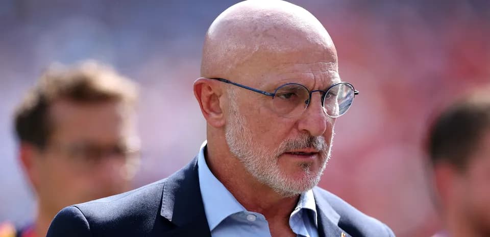 Man in glasses walking on sports field