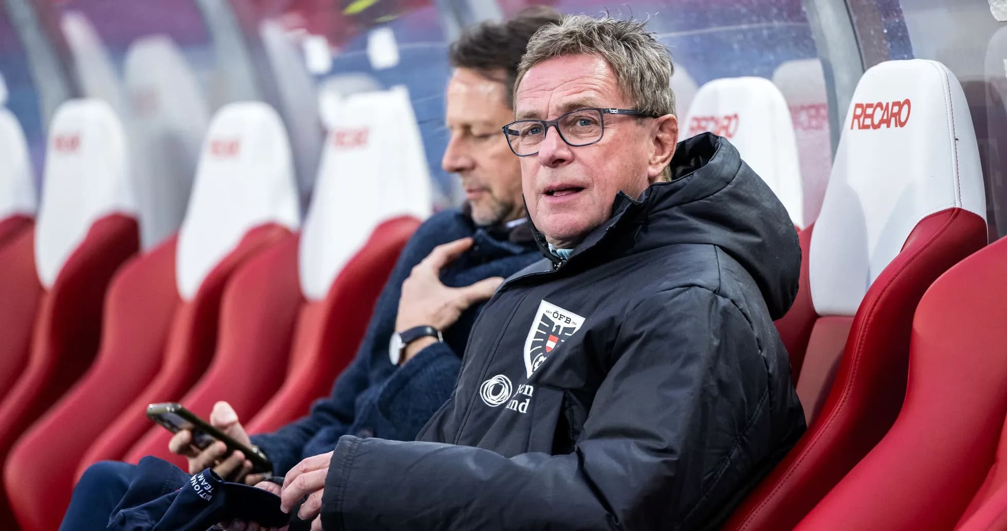 Coach sitting on the bench during a match