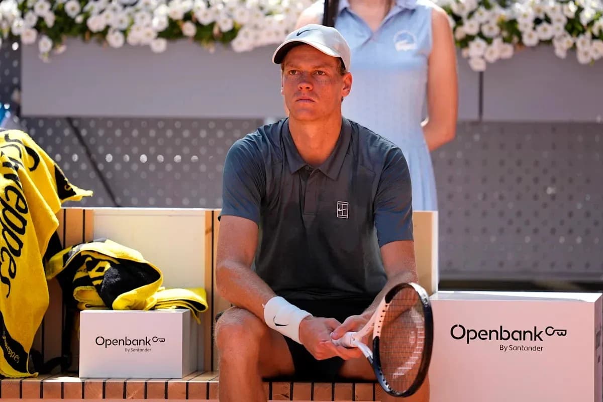Tennis player sitting on bench during match break