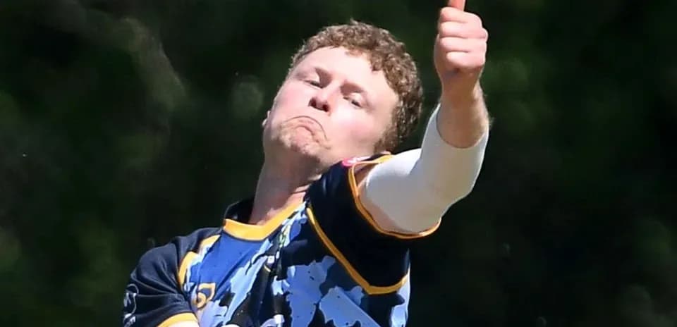 Bowler delivering a ball with a thumbs up gesture