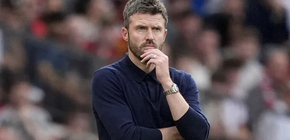Coach observing the match with a thoughtful expression