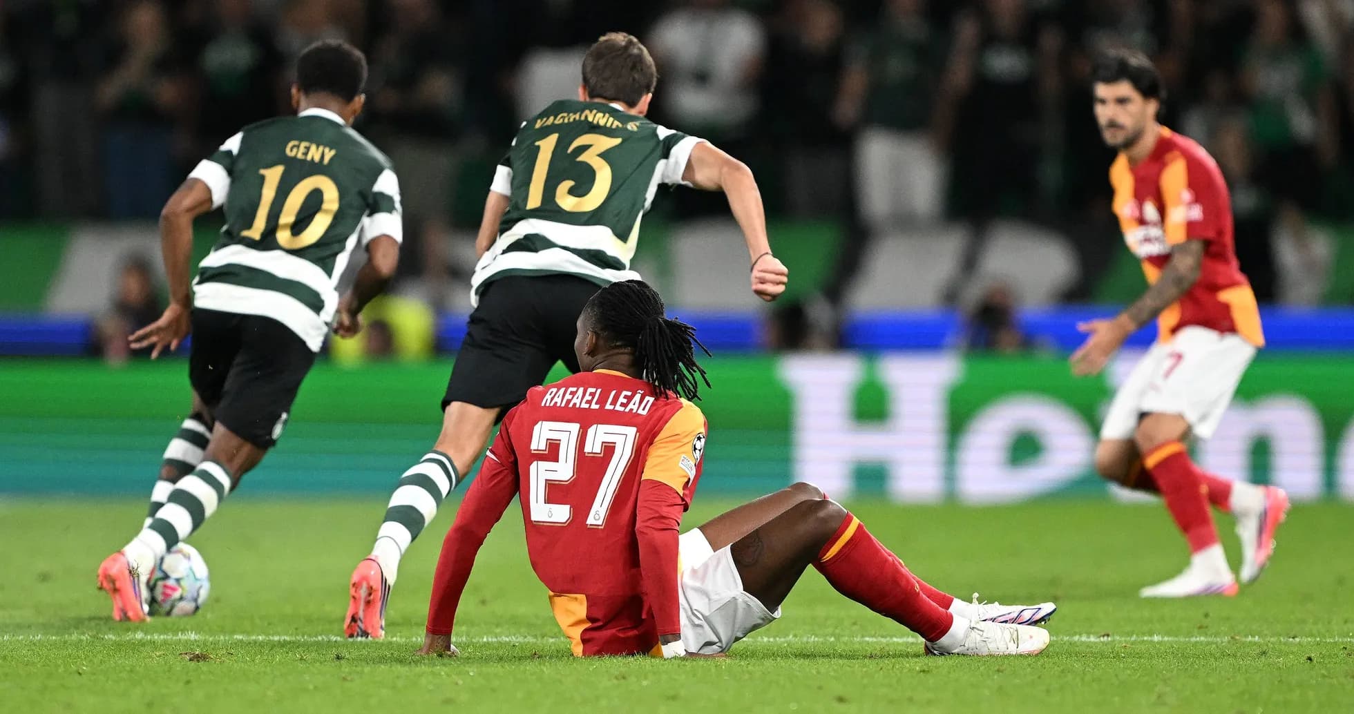 Rafael Leão sitting on the ground during match