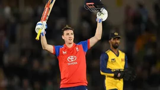 Batsman celebrating with raised bat after scoring