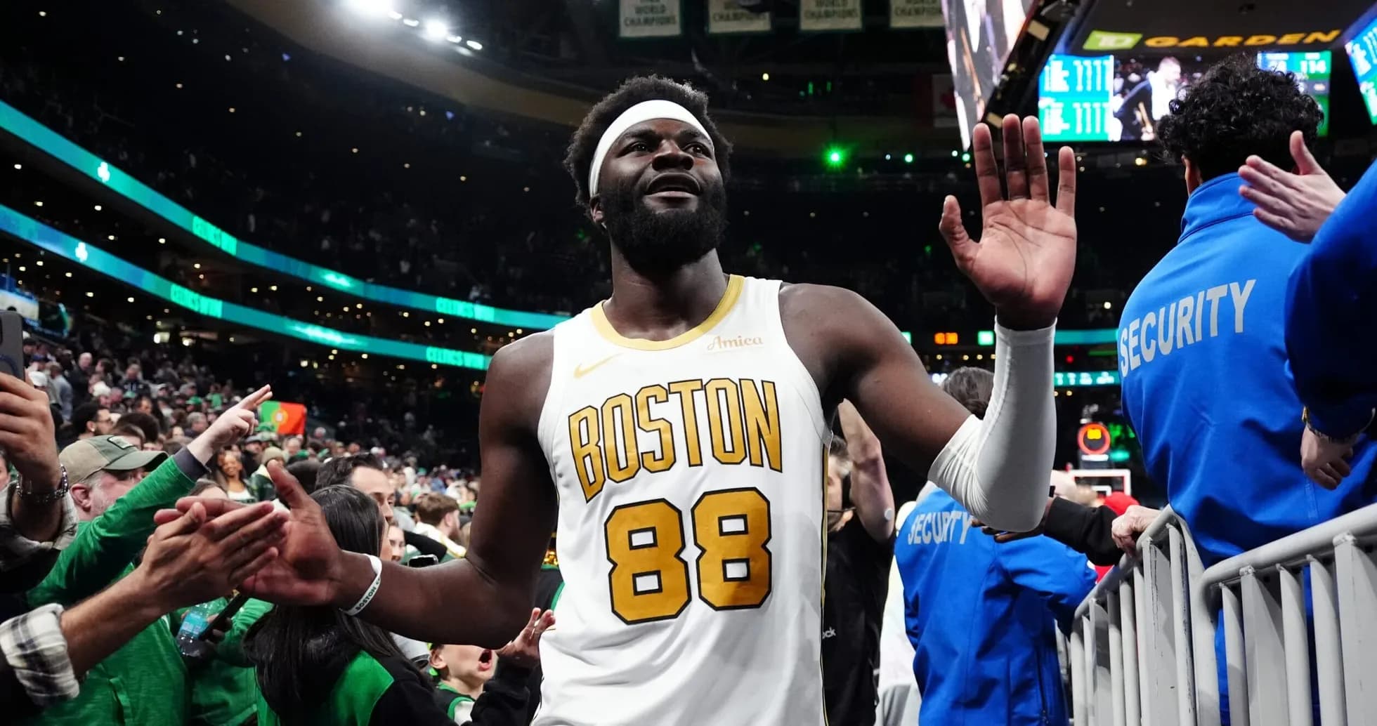 Player in Boston jersey waving to fans after game