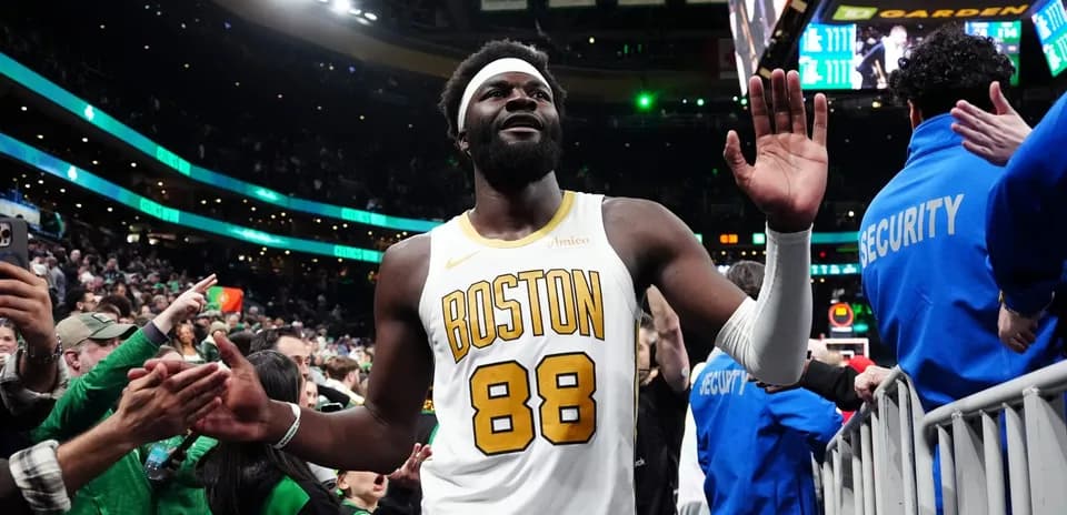 Player in Boston jersey waving to fans after game