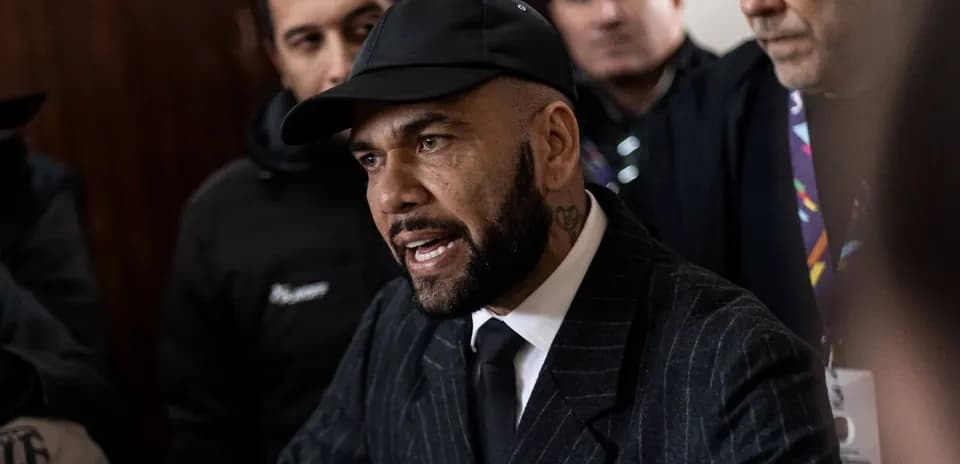 Man speaking surrounded by a crowd of people