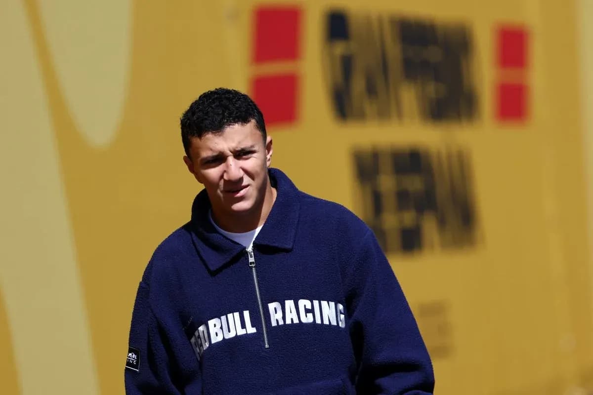 Young man in Red Bull Racing jacket walking outdoors