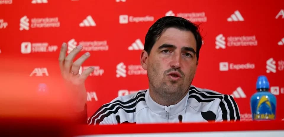 Manager speaking at press conference with backdrop