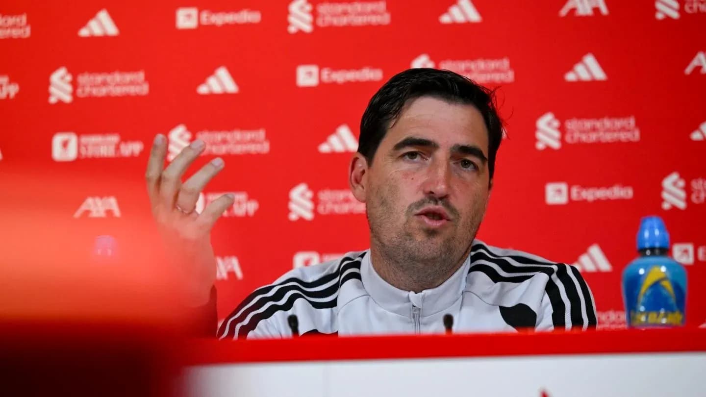 Manager speaking at press conference with backdrop