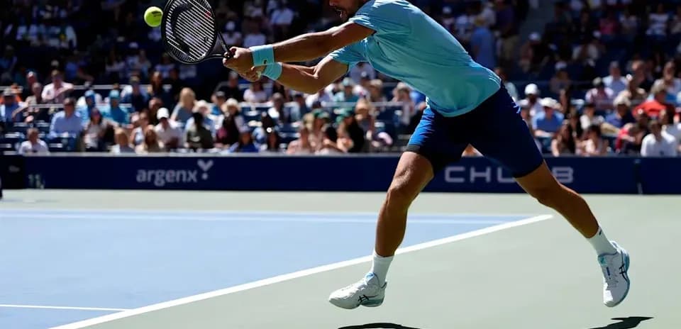Player reaching for a tennis ball during match