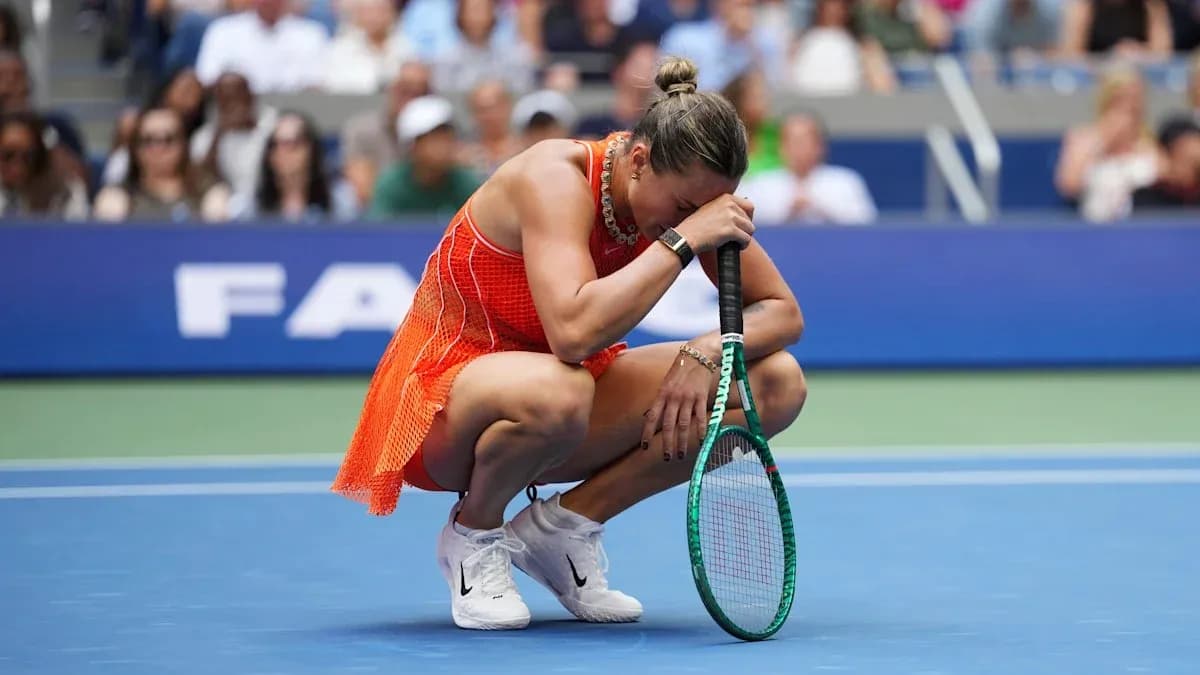 Player crouching on court holding racket during match