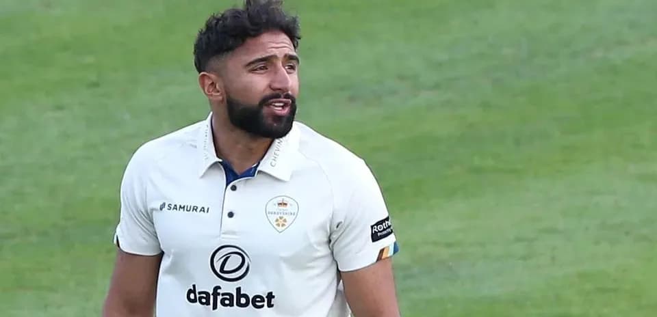 Cricketer in white kit on the field