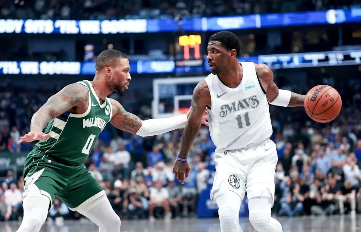 Two basketball players competing for possession of the ball