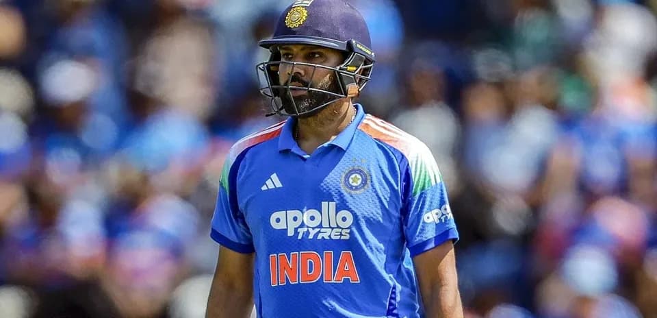 Indian cricketer in blue jersey walking on field