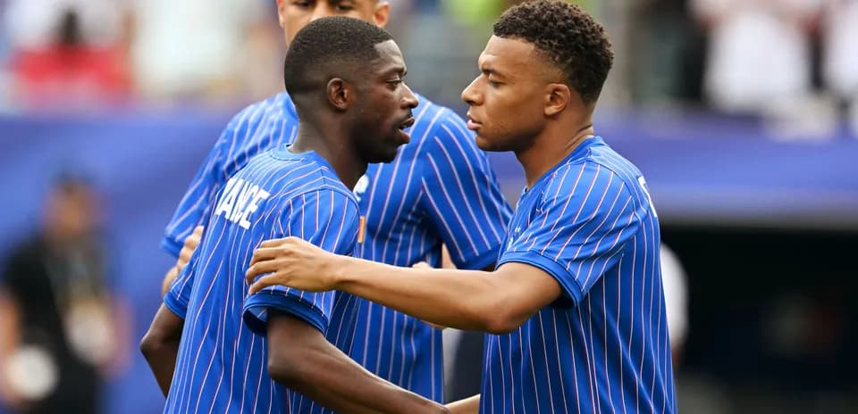 Two players in blue jerseys interacting on the field