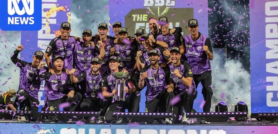 Winning team celebrating with trophy at championship event