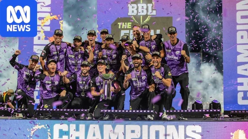 Winning team celebrating with trophy at championship event