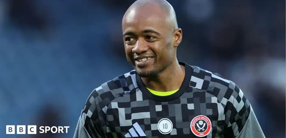 Goalkeeper wearing Sheffield United kit smiling