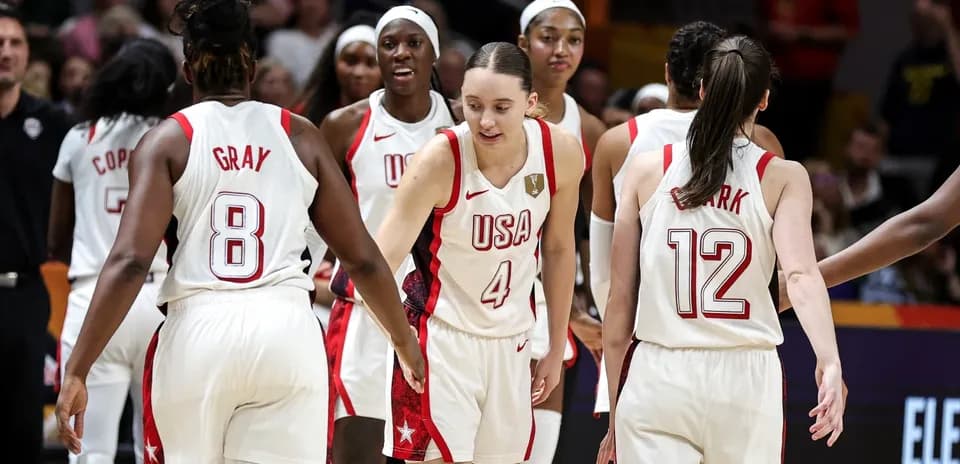 USA women's basketball team celebrating on the court