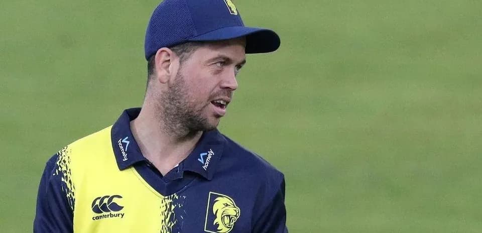 Cricketer in team jersey during match preparation