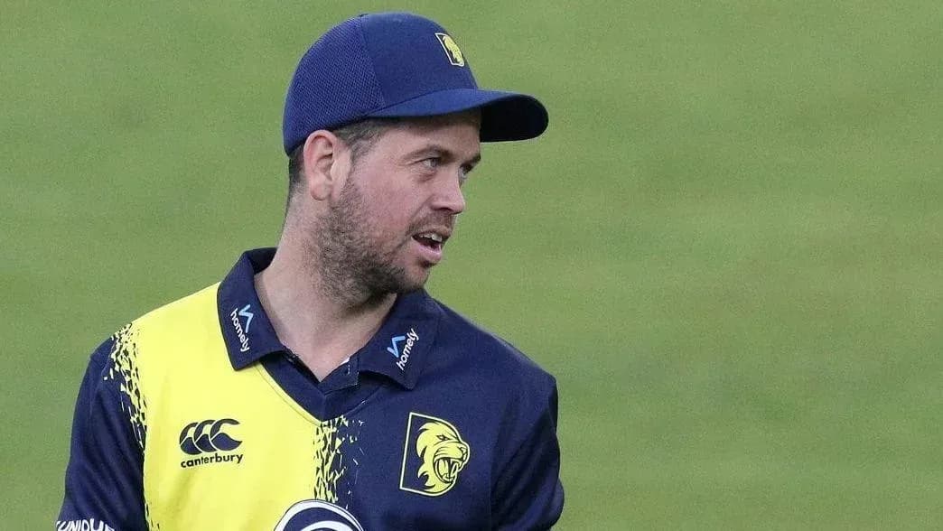 Cricketer in team jersey during match preparation