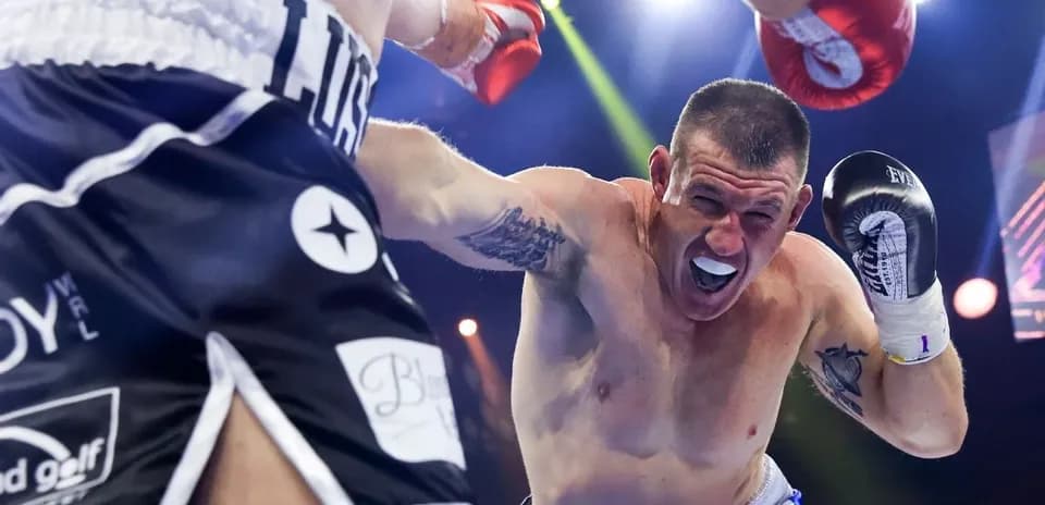 Boxer dodging a punch in the ring