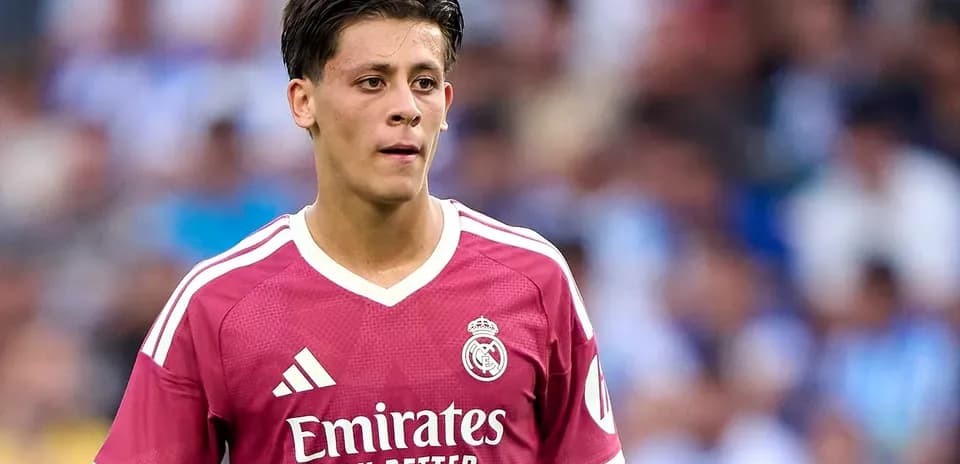 Player wearing pink Real Madrid kit on field